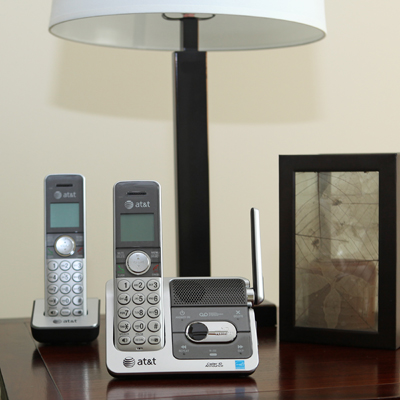 AT&T® DECT 6.0 Cordless Phone with Talking Caller ID and Digital Answering System - This single line cordless phone, with two handsets, features a digital answering system with 14 minutes of record time.  The caller ID announce gives you the ability to hear the name of incoming callers without having to look at the phone.  Features include conferencing abilities, handset speakerphone, remote access and call transfer using intercom.  Contains base, two handsets, one charger and line cord.